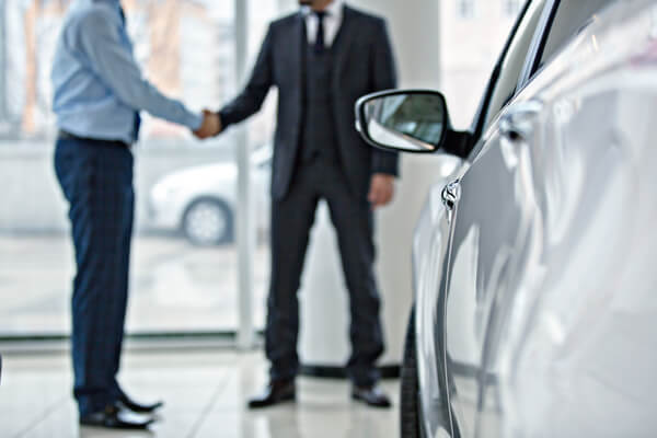 men shaking hands at arizona car dealership