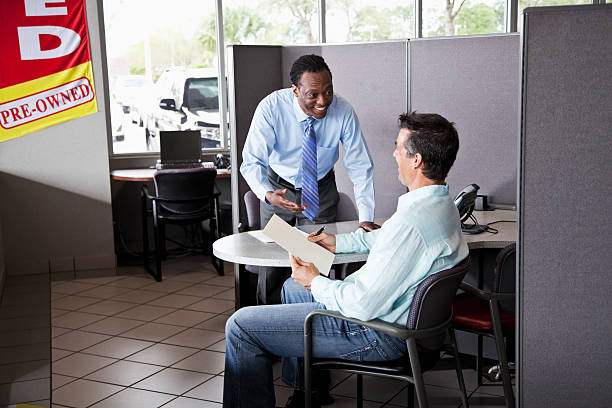man meeting with loan officer | buy here pay here lots in phoenix AZ