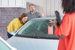 dad and daughter happy with affordable used cars