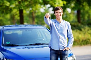 young man standing in used car lots in phoenix, used car lots in phoenix az