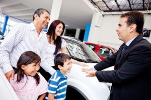salesman speaking to family | Certified Pre Owned Dealership Articles