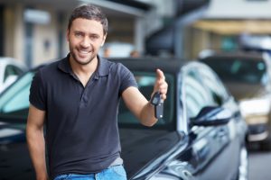 young man buying used car | buy here pay here arizona